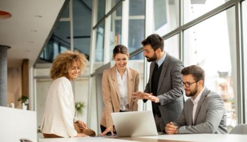 Office staff looking at a laptop
